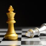 A golden chess king standing victorious over a fallen silver king, symbolizing India’s rise and Western decline in global chess